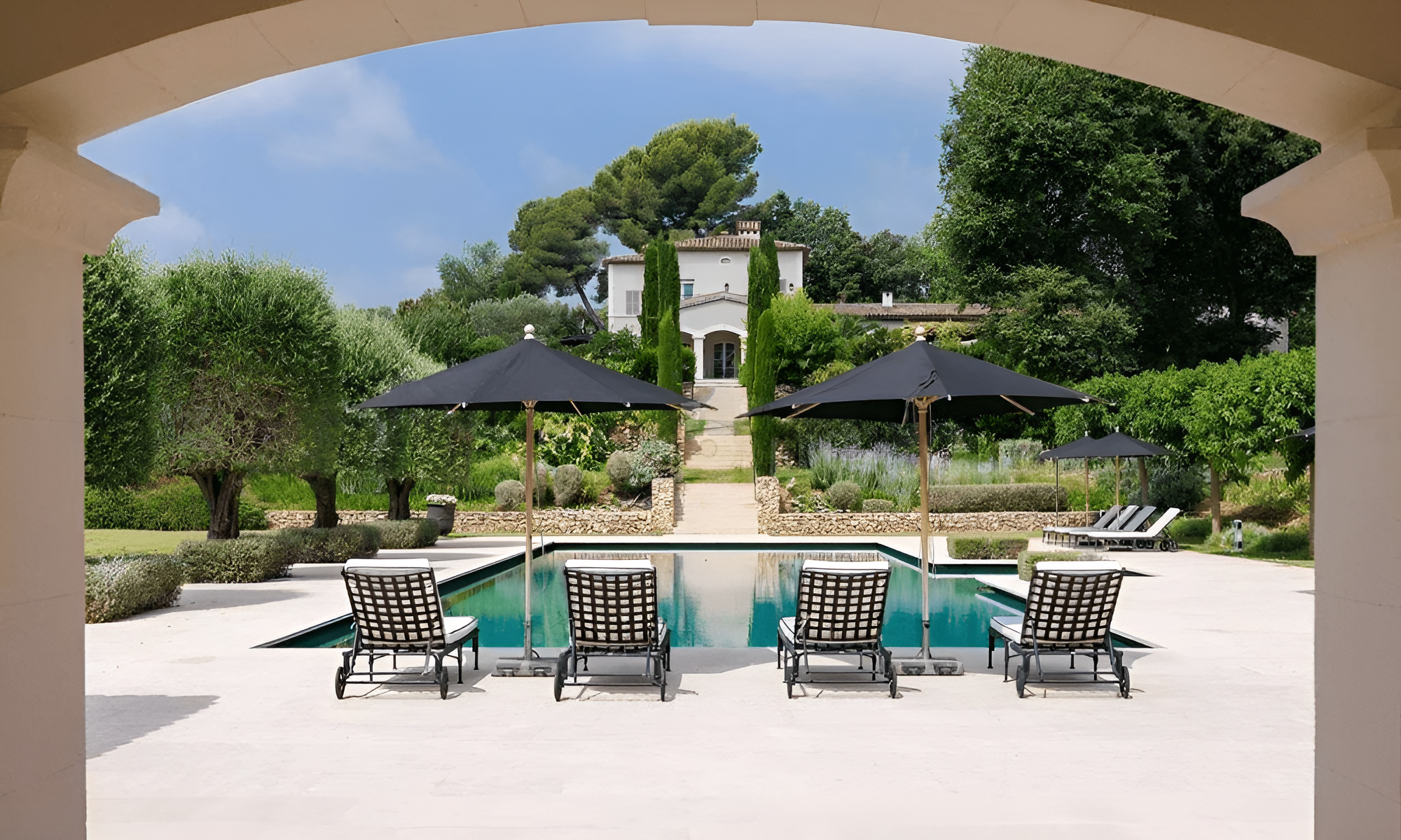 Outdoor lounge area with pergola and greenery